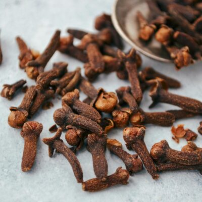 Close-up of Cloves Scattered on Gray Surface